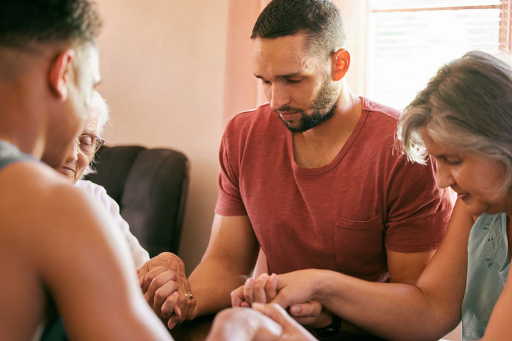 Family praying about becoming a pastor