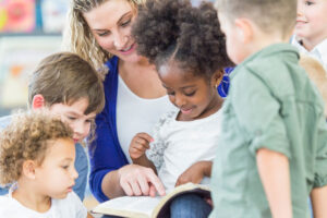 Teacher reading bible together with students