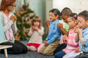 Sunday school kids praying together