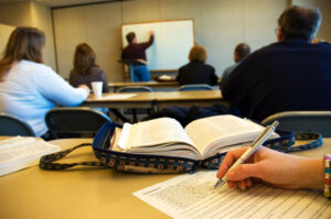 Bible study class in full classroom of students