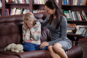 Christian counselor with young girl in therapy