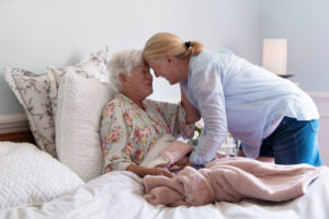 embracing mother in bed on hospice