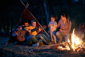 Family camping around the campfire