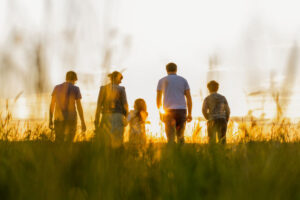 Family of five walking in a field