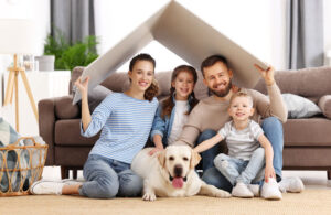 Family in living room fort with their dog