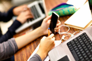 Female student working on laptop in classroom