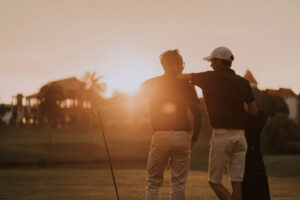 Golfers on golf course at sunrise