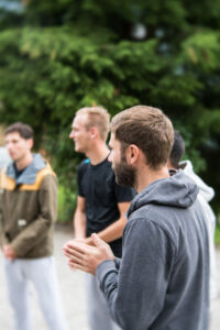 Group of young men outside praying