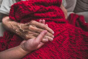 Holding hand of hospice patient