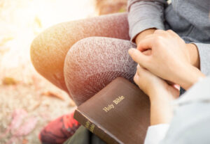 Holding hands over bible