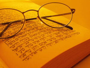 Open page Torah with glasses on book