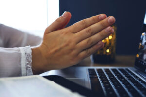Praying at computer while taking ministry classes online