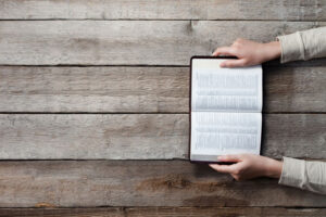 Woman reading and praying over the bible