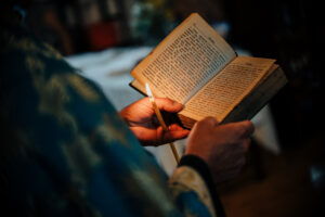 Bishop with bible and candle