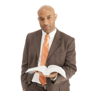 Adult African American male Minister Preacher Priest holding the Bible