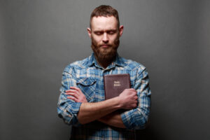 Man praying over Bible