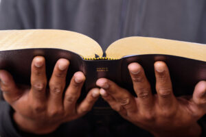 Pastor holding open bible