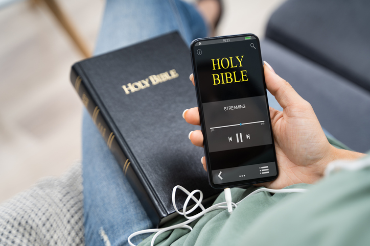 pastor using technology to listen to bible