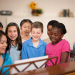 Youth Pastor singing with Children