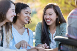 college students laughing and praying together